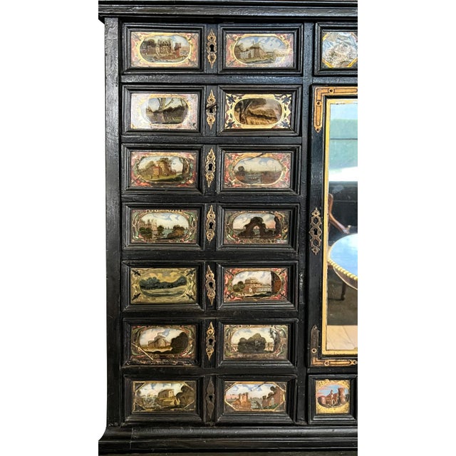 Slightly arched top that may have held a bust at some point, over a middle section with drawers with reverse painted...