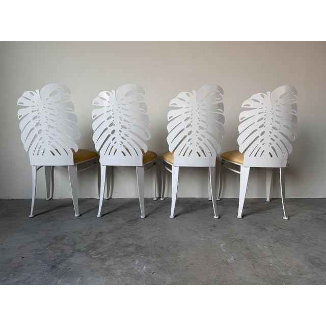 Stylish set of four Johnston Casuals dining chairs featuring eye-catching Monstera leaf silhouette backs. Crafted with a...