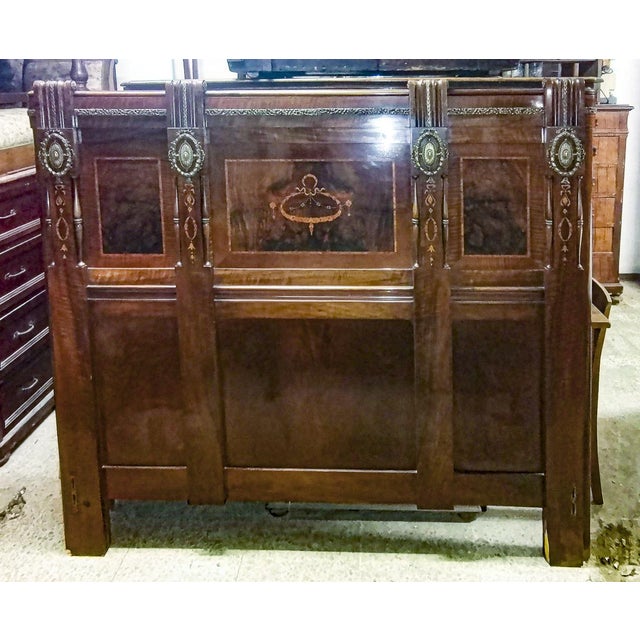 Art nouveau room bed with inlays and decorations in worked brass. Consisting of headboard that has the following...