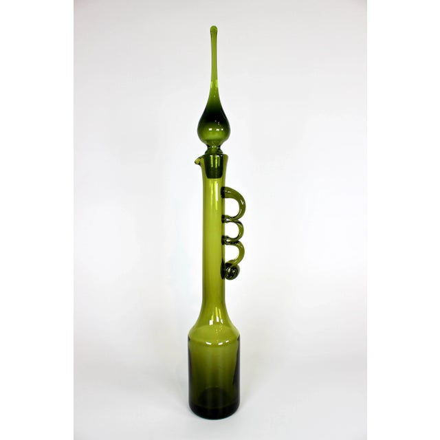 For your consideration this stunning and exceptionally rare hand blown green glass decanter with flame tipped stopper....