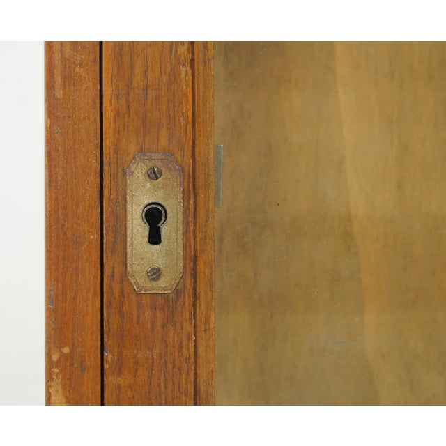 This double sided piece is a vintage industrial shop counter display and storage cabinet, specifically manufactured by...