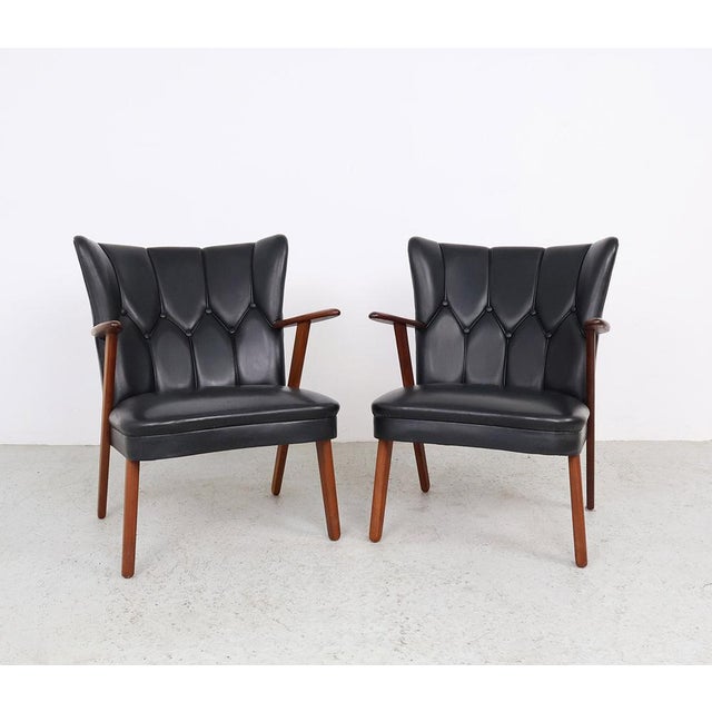 Beautiful set of danish teak and faux leather armchairs, produced in the 1960s by erhardsen & andersen, also known as eran...