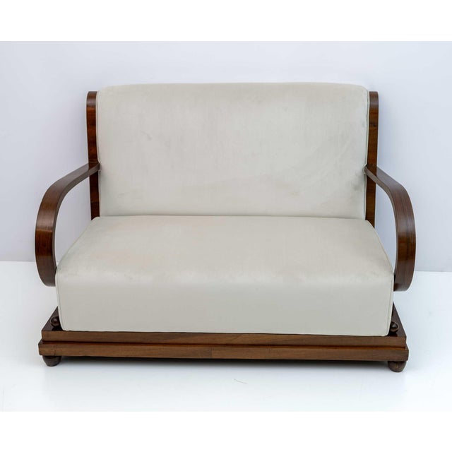Early Art Deco period Northern Italian sofa, in walnut and ivory velvet upholstery, the back of the sofa is gracefully...