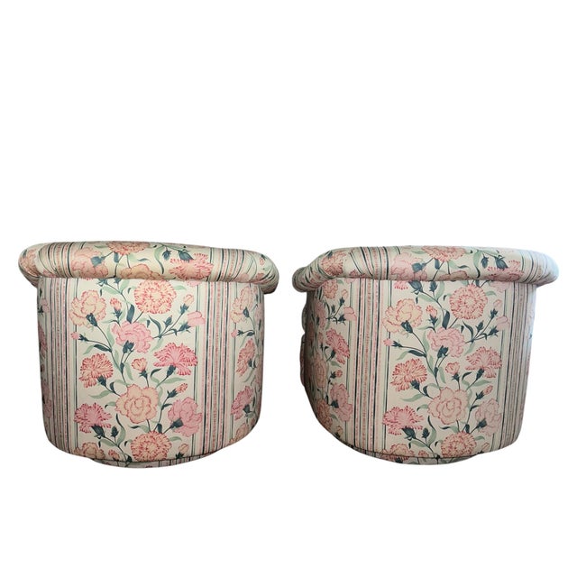 Matching pair of mid Century swivel lounge chairs by Directional. Plinth base, full swivel and tilt. Floral cotton chintz,...