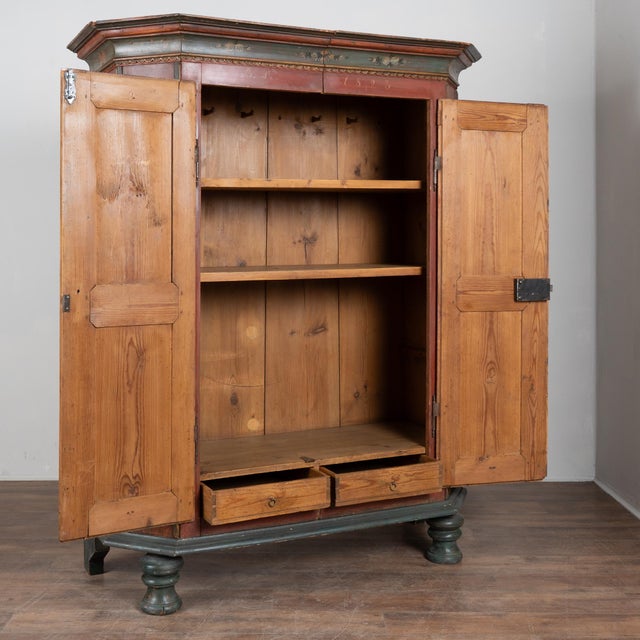 Early 19th century Swedish armoire constructed of pine and dated 1823, featuring its original hand-painted finish. The...