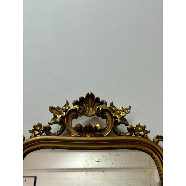 Michele Grasso, sculptor, Gilded wood mirror dating back to the 1950s. It features a contoured frame with carved floral...
