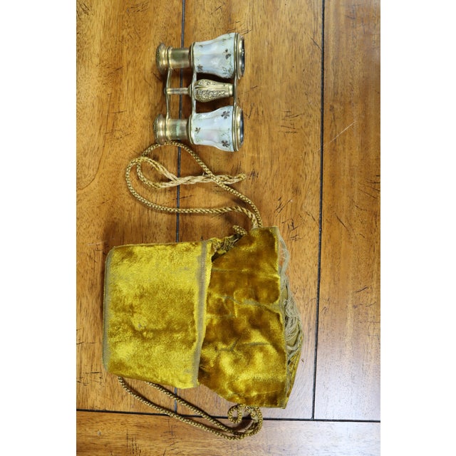 French mother of pearl opera glasses with etched design and original case.
