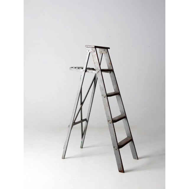 This vintage painter’s wooden ladder has the character and patina that come from years of practical use. The softly...