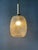 Mid-Century clear glass pendant lamp with leaf-like pattern. The patterned glass fractures the light, spreading it...