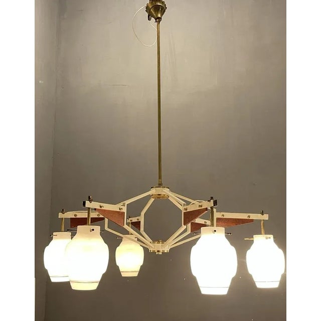 Italian geometric stilnovo chandelier from the 1950’s. wooden veneer metal frame with brass fittings. glass shades. height...