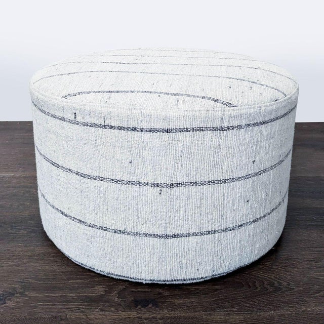 Handcrafted in India by THE ARTISANS OF DURGAPURA, the ottoman is handwoven using soft, yet durable cotton and features a...