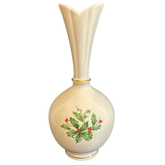 This porcelain bud vase is part of Lenox's Holiday collection. The pattern features the iconic holly leaves and red...