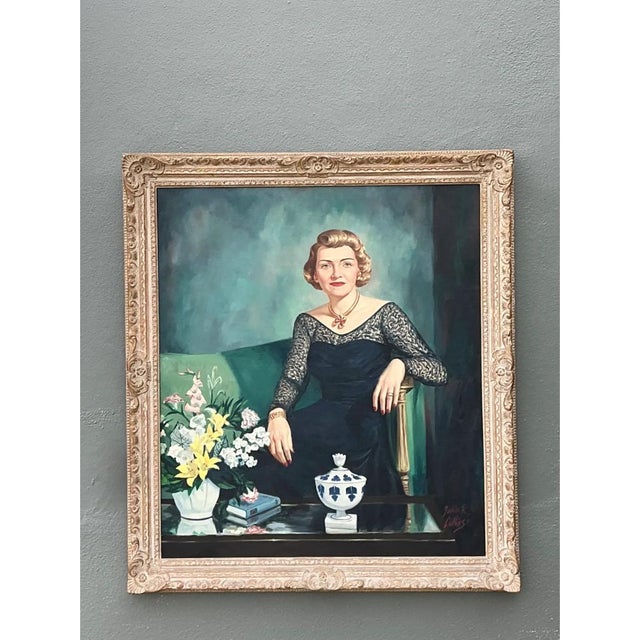 This vintage oil portrait captures a poised woman seated in an elegant interior, rendered with the polished realism of...