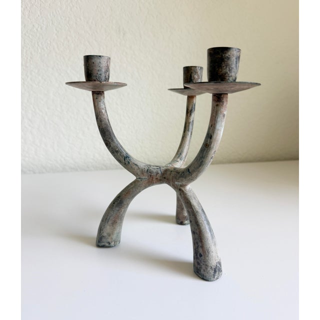 This brutalist-style verdigris candelabra is a vintage late 20th century sculptural piece characterized by its raw, heavy...