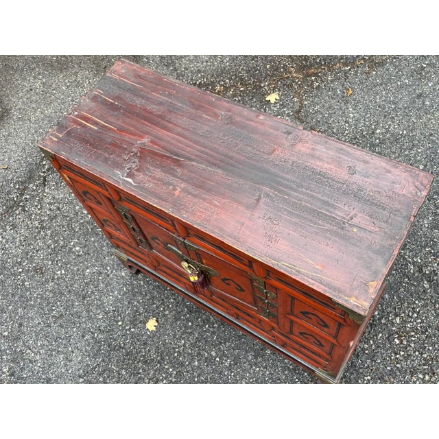 Early 20th century Korean tansu style double door wooden cabinet decorated with metal mounts, butterfly hinges, lock and...