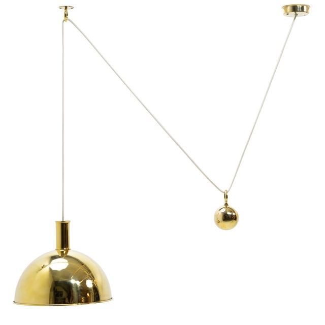 Height adjustable counterweight pendant attributed to florian schultz. The brass components have been polished and left...
