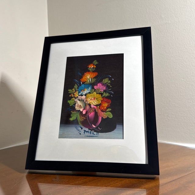 Beautiful vintage floral still life painting featuring a vibrant bouquet of multicolored flowers arranged in a decorative...