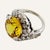 This is part of Chairish’s Fine Jewelry assortment. Large yellow sapphire set in 14k white gold with a diamond surround....