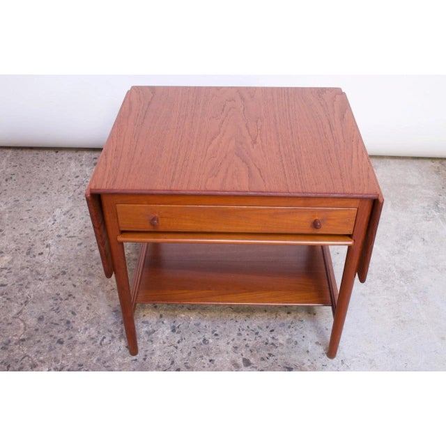 1950s Danish solid teak sewing or side table (model AT33) designed by Hans J Wegner and manufactured Andreas Tuck. Crafted...