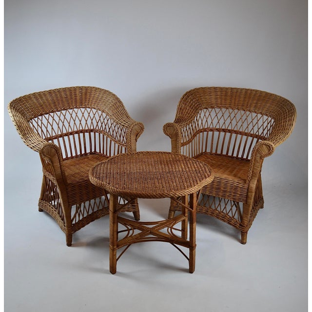 Sculptural Mid-Century side table featuring an unusual biomorphic free-form woven wicker top and an elaborate rattan base,...