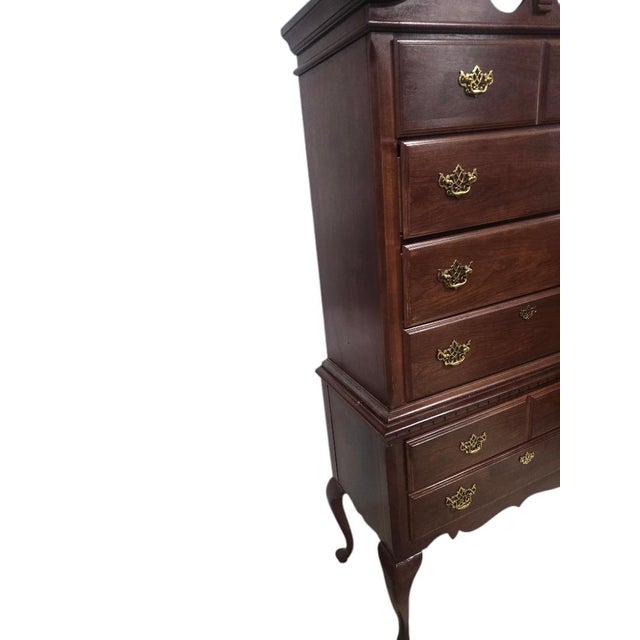 An elegant vintage 2 piece Broyhill Queen Anne-style cherry highboy chest featuring a classic chest-on-chest design with...