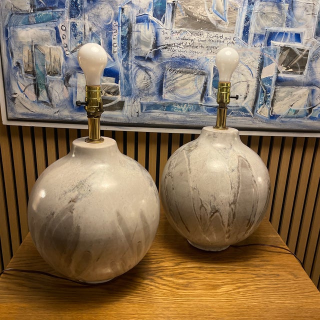 A sculptural pair of hand-thrown ceramic table lamps with an earthy matte mineral glaze—organic, timeless, and...