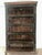 Beautiful Indian wood bookcase with detailed hand-carved decorative panels and touches of green, red, and natural wood...