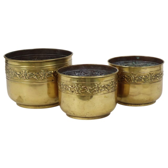 Set of 3 vintage repoussé planters, cache-pots, or jardinières made of brass; manufactured in France during the first half...