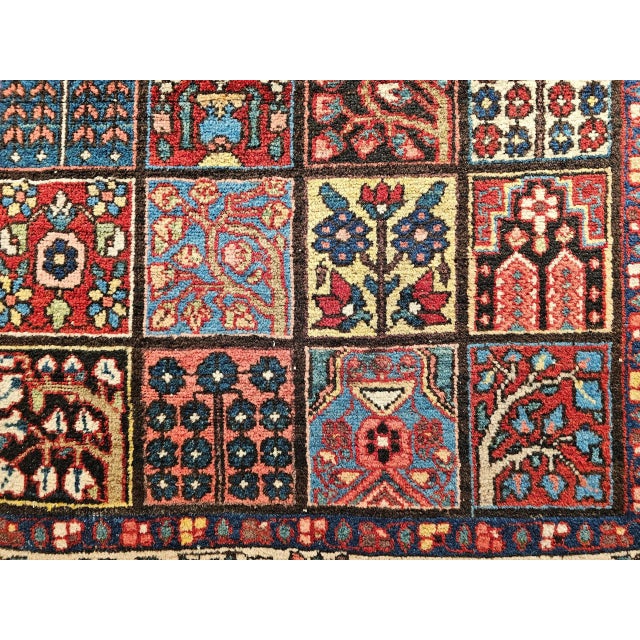 This exquisite vintage Persian Bakhtiari rug from the second quarter of the 20th century features the highly coveted...