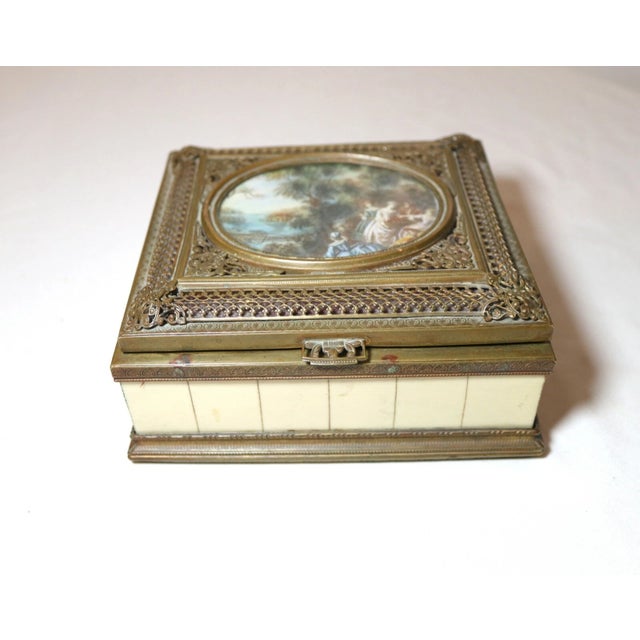 Up for sale is a wonderful antique ornate Italian bronze box. It has an original hand painted miniature figural landscape...