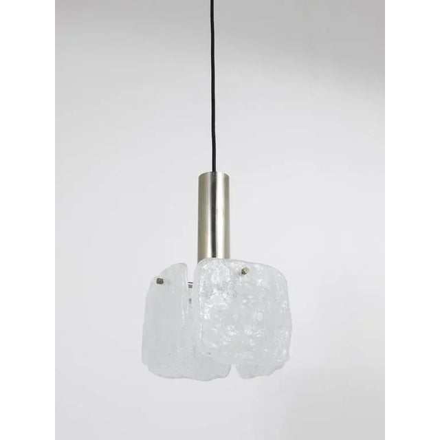 A beautiful pendant light, manufactured by Kalmar Austria in the 1960s. Stainless steel hardware with one light source and...