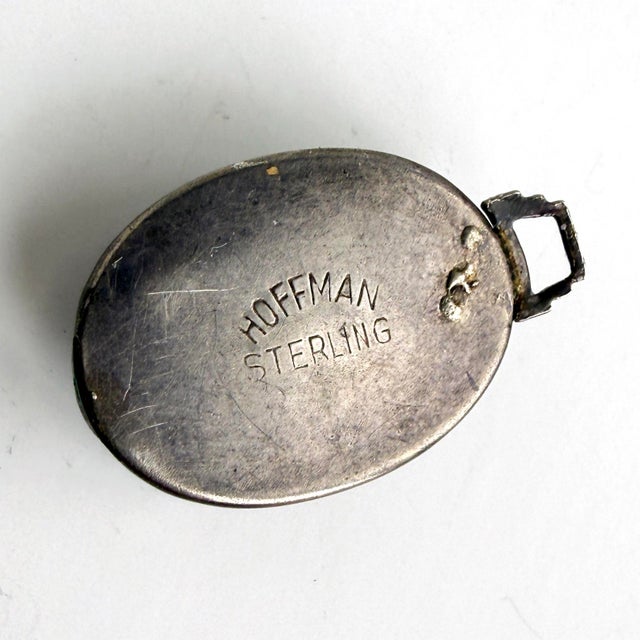 A lovely vintage pendant from Hoffman, featuring a butterfly wing under a glass dome and set in sterling silver