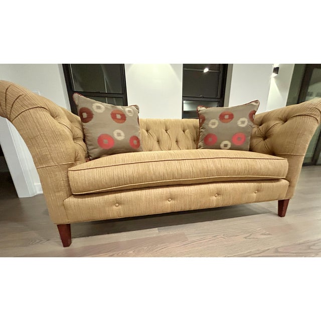 Chesterfield-style sofa with a contemporary update, suitable for modern decor preferences. It features classic deep...