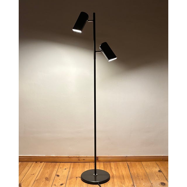 This elegant gunmetal brown two-light floor lamp features omi’s renowned articulating joints and reflects the precision...