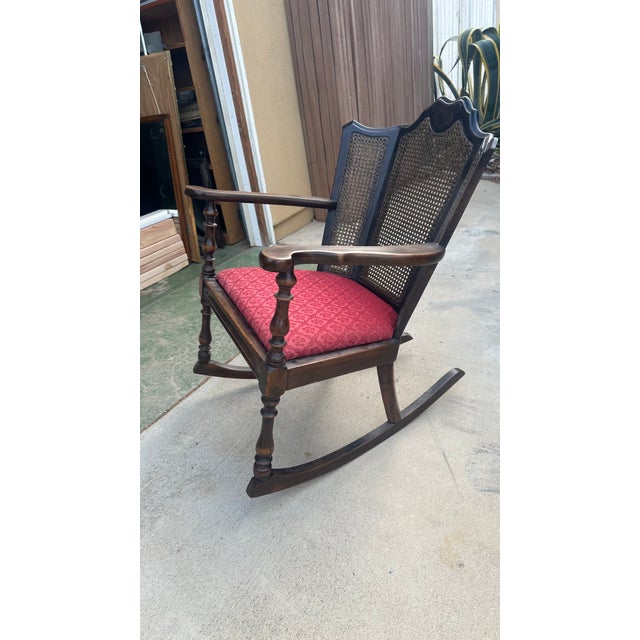 A beautifully crafted Jacobean Revival style rocking chair from circa 1910–1920, featuring turned legs, ornate carving,...