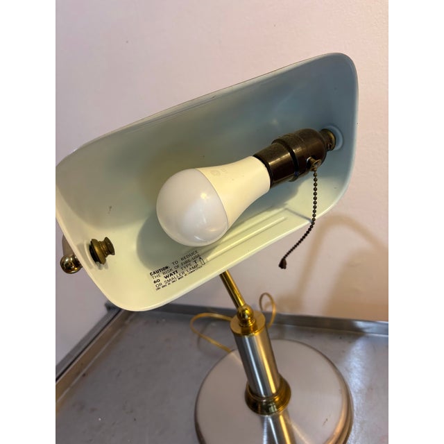1970s-80s silver/brass mixed metal banker's style desk lamp. Excellent condition. Measurements 14" tall 9" length of light...
