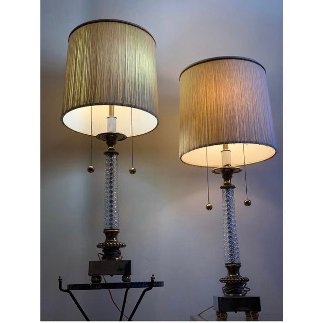 Stunning pair of Hollywood Regency–style table lamps featuring: Lamps are attributed to Paul Hansen Cut-glass crystal...