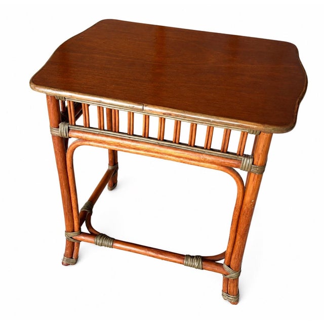 Beautiful vintage rattan side table featuring bamboo-inspired detailing, wrapped joints, and a warm wood top with a rich...