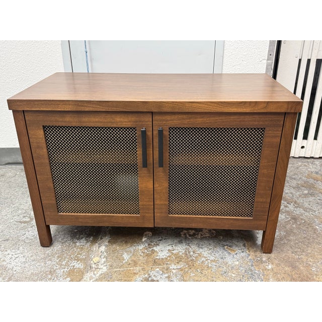 Design Plus Gallery presents a Bespoke Media Cabinet. The cabinet is constructed in walnut-toned wood with a broad...