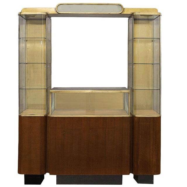 Rare large double tower Streamlined Art Deco display case comprised of a center waist-level glass display case with a...
