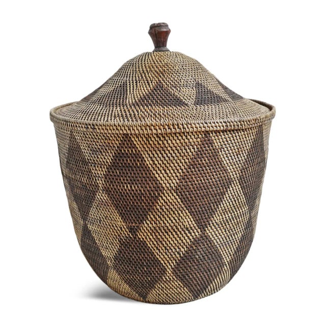 Beautiful hand woven diamond pattern tea stained basket with lid. Intricate carved wood knob on top. Handmade piece each...