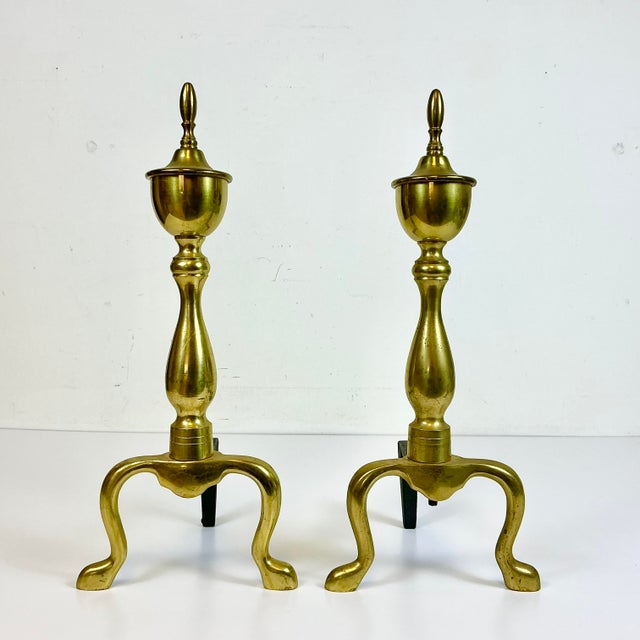 Vintage Home is pleased to offer this pair of Brass Federal style Andirons. They have wrought iron stands and are perfect...