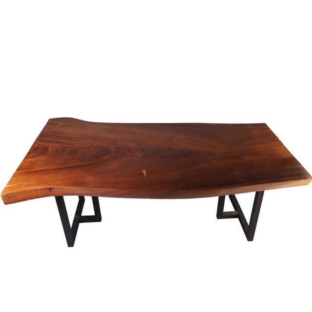 The design of this dining table is inspired from the shape of original wood slab. The top is hand polished to display...