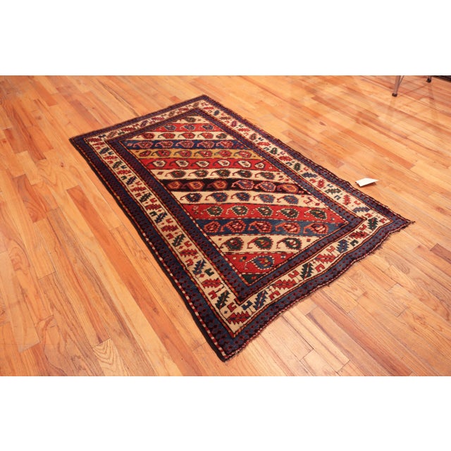 Antique Caucasian Kazak Rug with Diagonal Paisley Motifs and Tribal Charm, Country of Origin: Caucasus, Circa Date: 1900