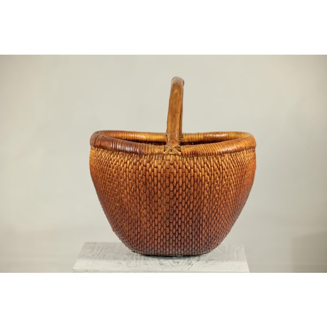 "About the Item This vintage Chinese rattan carrying basket is a beautifully crafted example of traditional handwoven...