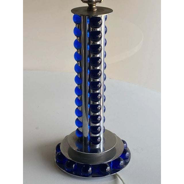 Crafted around 1930, the chromed steel and cobalt marble machine age art deco lamp is a striking blend of sleek design and...