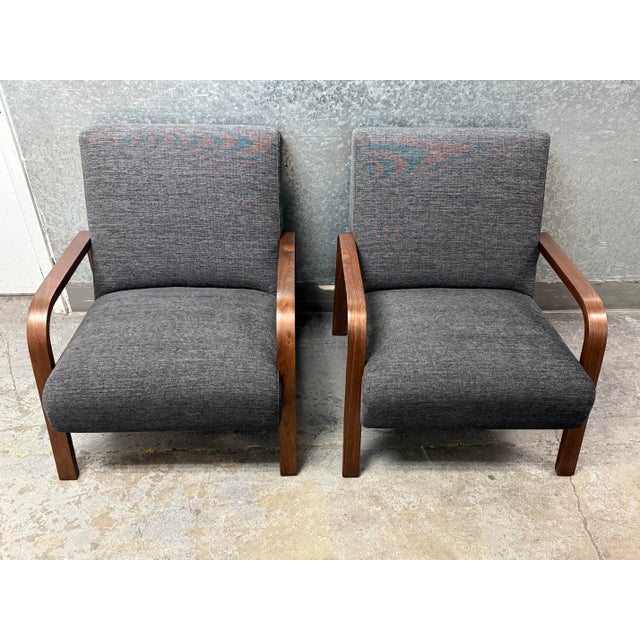 Design Plus Gallery presents a Pair of Custom Designed Charcoal Linen Felix Lounge Chairs. The chairs welcome you with...