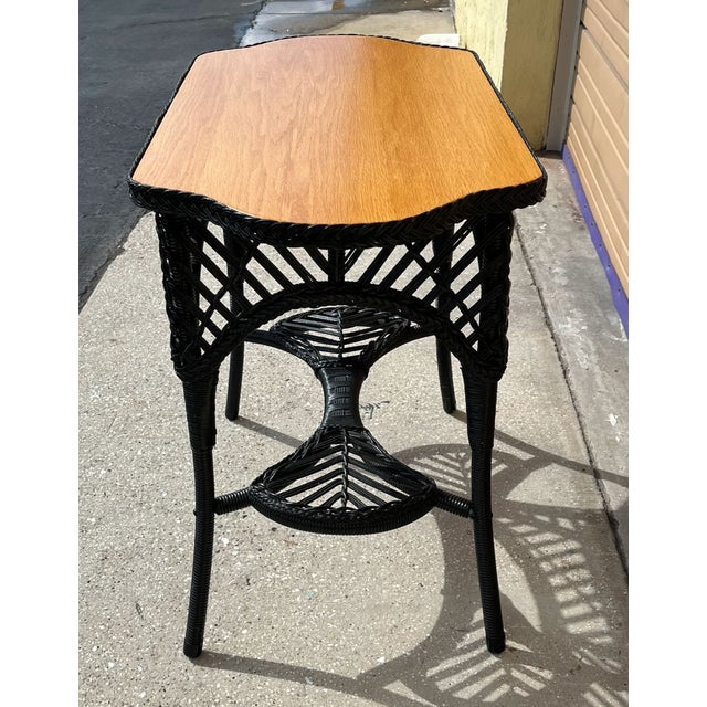 Heywood Wakefield style wicker table with oak top. At some time in its long life the table's base was repainted and the...