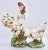A superb pair of ceramic chickens, a rooster and hen. This is a fine, creamy white pair with bright green bases. There is...