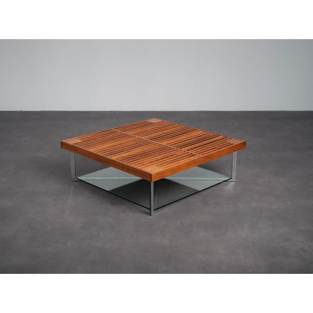 A refined ponton coffee table designed by osko + deichmann for ligne roset in 2006. The design combines a warm walnut...